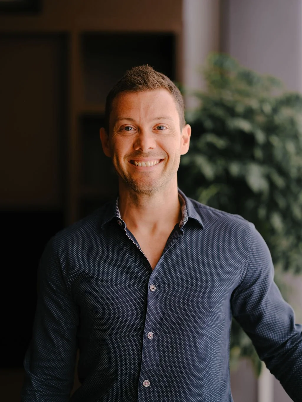 Dr Daniel Niemiec, smiling, in a navy shirt